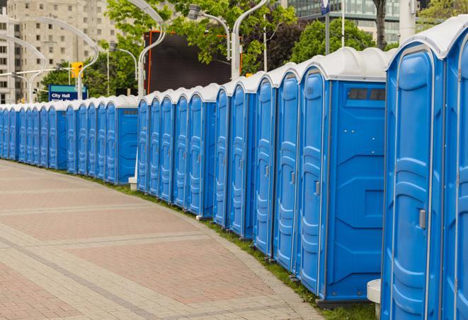 a row of portable restrooms set up for a large athletic event, allowing participants and spectators to easily take care of their needs in Bradner